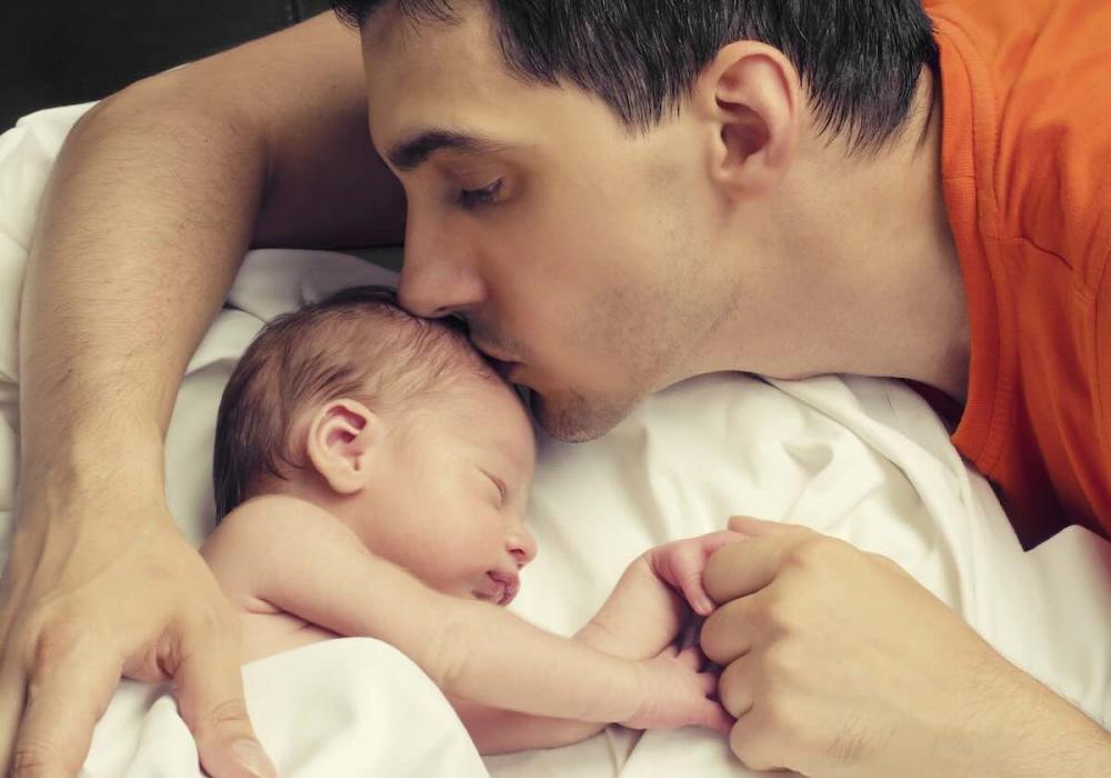 Father kissing baby