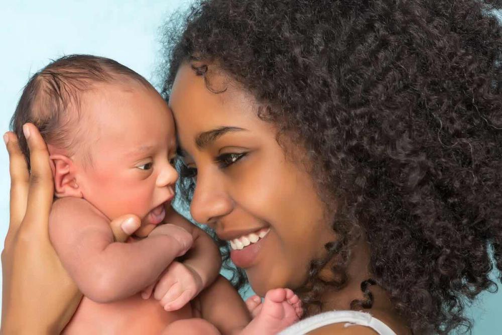 mother holding baby