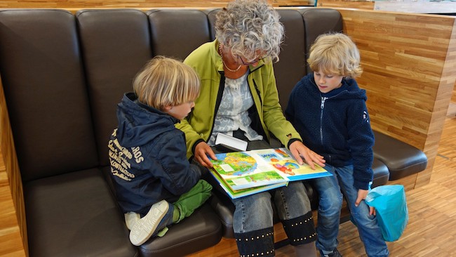Mother reading to kids for language development