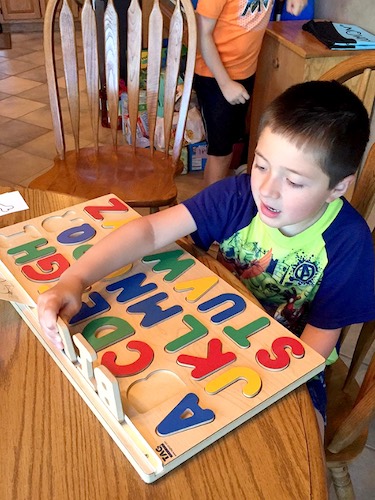 Child with Spelling Board