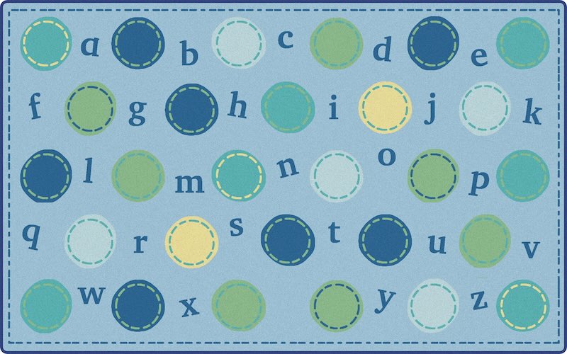 A blue pallet color themed classroom rug with circles that contain letters of alphabet. Each letter of alphabet is in a circle of different color but the overall color theme is light blue.