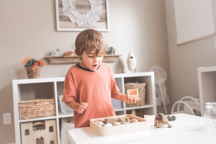 Boy playing with Montessori toy