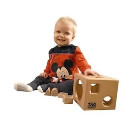 Leo is smiling while playing with the Montessori Shape Sorting Cube