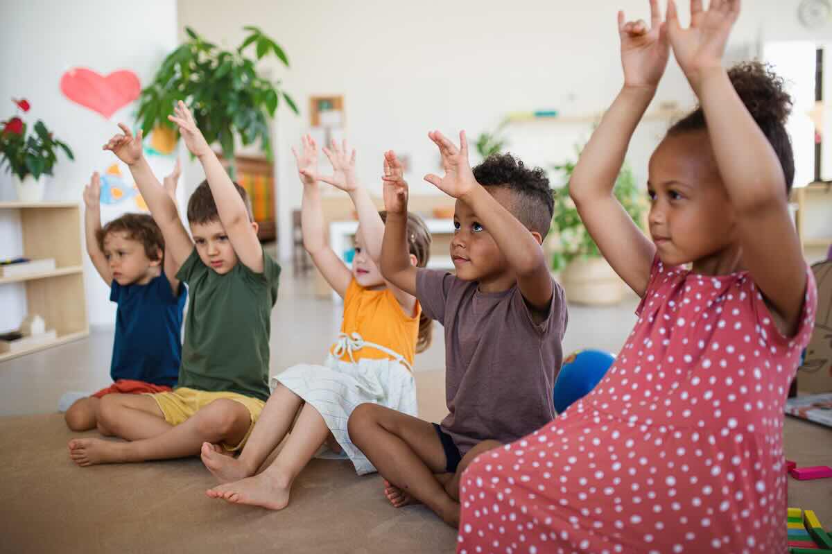 Children clapping on a circle time rug